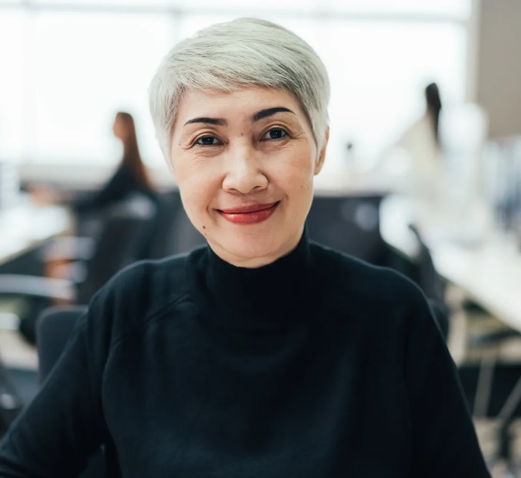 portrait-of-asian-senior-female-manager-at-desk-in-the-office